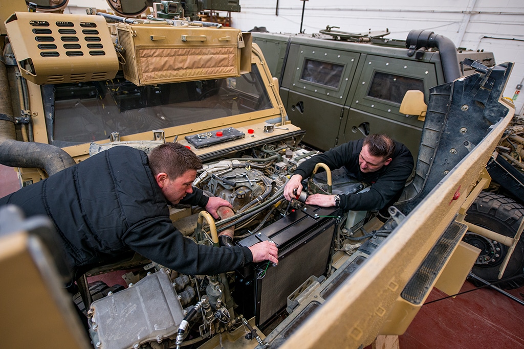 Men Working on Military Vehicle
