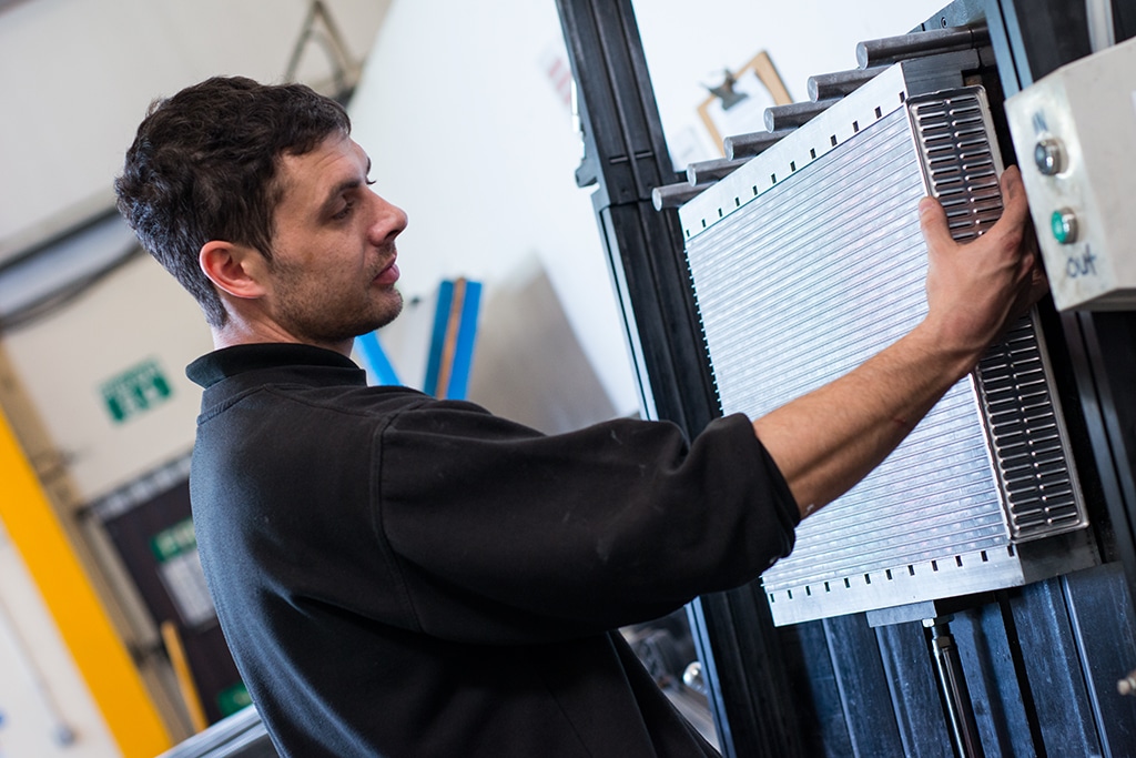 Man Handling Car Radiator