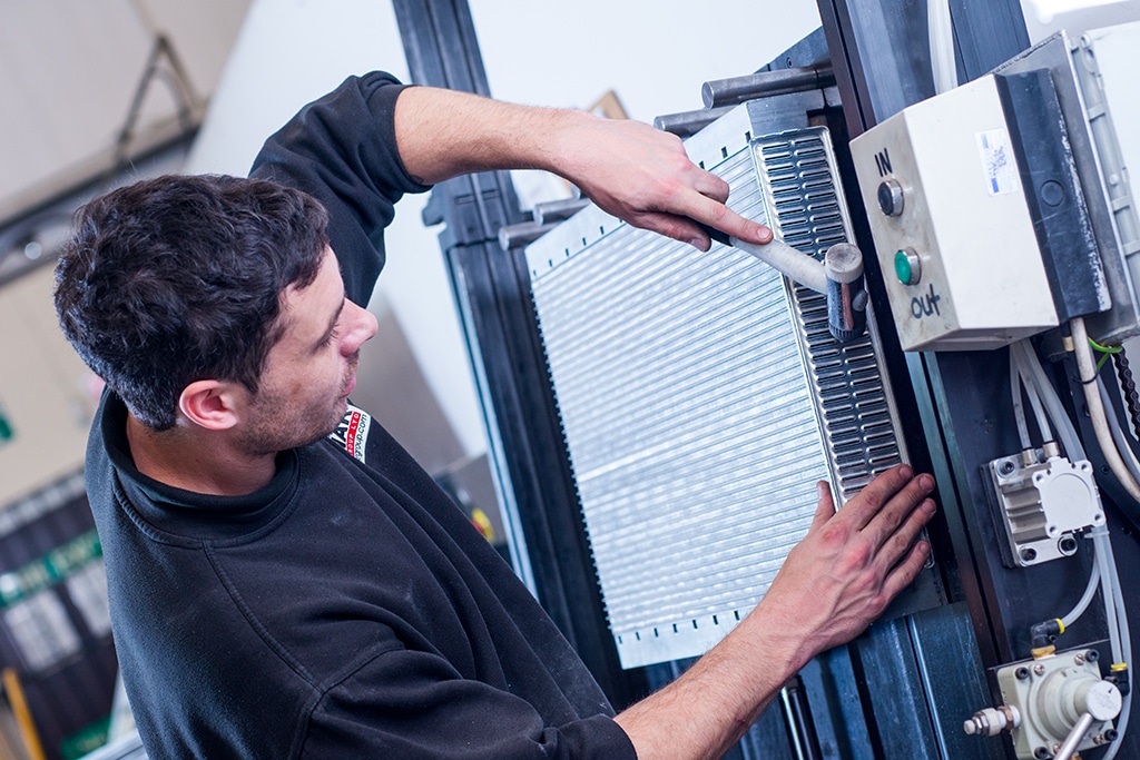 Man Handling Car Radiator Close Up