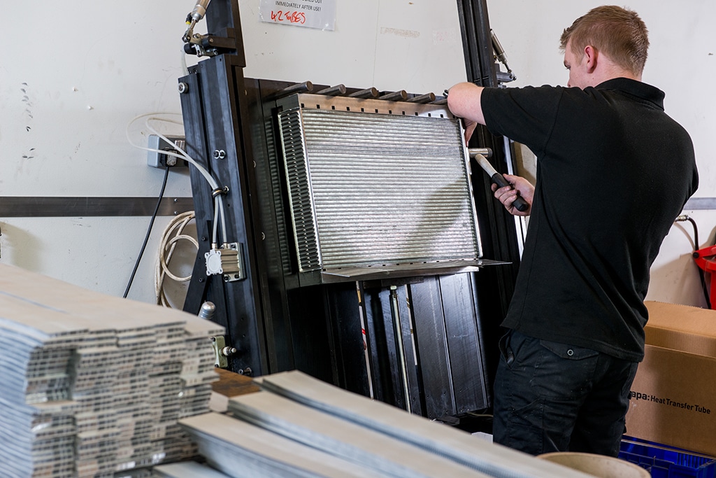Man Working on Aluminium Radiator for Car