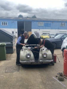 Wide angle of NAR Group team working on Jaguar XK120